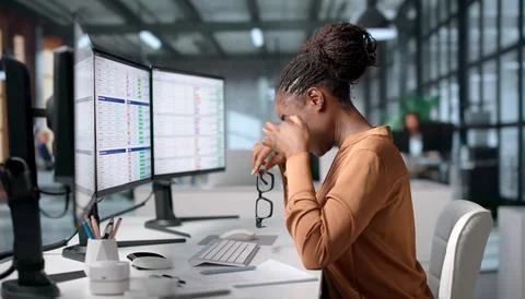 Medical Coder Carefully Reviews Billing Codes On Computer In Office. Stock Photos