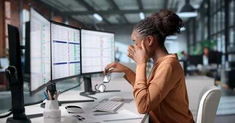 Medical Coder Carefully Reviews Billing Codes On Computer Screen. Stock Photos