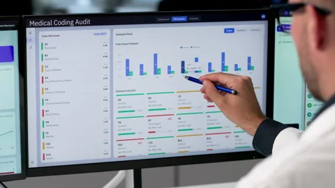Medical Coder Carefully Reviews Patient Records Using Laptop Stock Footage 340997695