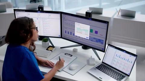 Medical Coder Carefully Reviews Patient Records On Laptop Stock-Footage 344716976
