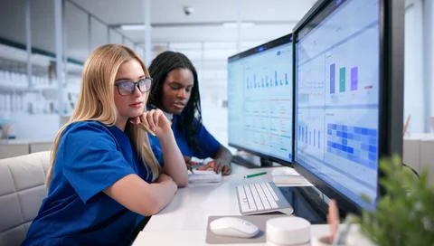 Medical Coder Examines Patient Claims Data For Accurate Billing Processes. Stock Photos