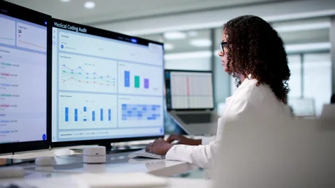 Medical Coder Reviewing Patient Files Carefully For Accurate Billing Stock Footage 339190936
