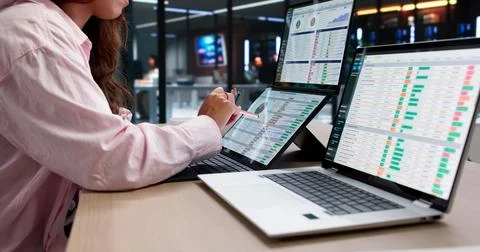 Medical Coder Reviews Billing Codes On Dual Touchscreen Laptop Carefully. Stock Photos