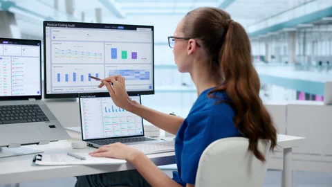 Medical Coder Reviews Clinical Documentation Carefully Using Laptop Stock-Footage 345328562