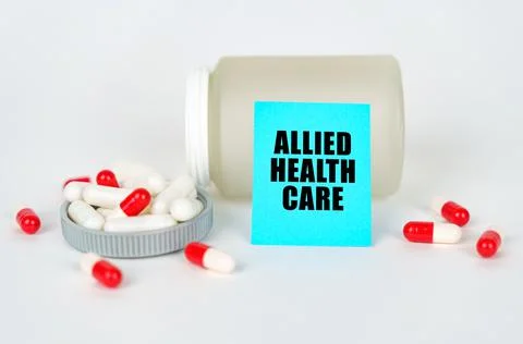 Medical concept. On a gray background, a jar, capsules and a sign with the in Stock Photos