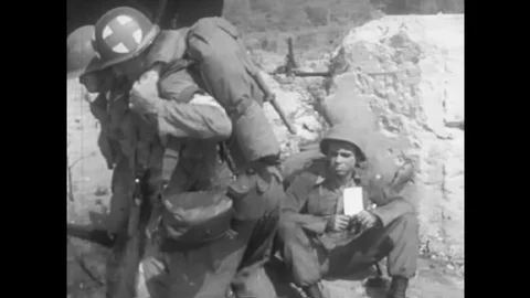 A medical core soldier delegates a task to help a distressed soldier to one of Video stock 145416499