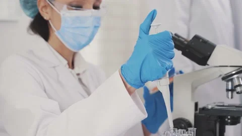 Medical Development Laboratory: Looking Under Microscope, Analyzes Sample Stock Footage 171765275