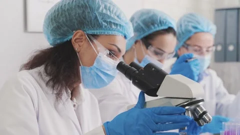 Medical Development Laboratory: Looking Under Microscope, Analyzes Sample Stock Footage 230243990