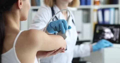 Medical device examines elbow joint of woman on medical ultrasound Stock Footage 253995459