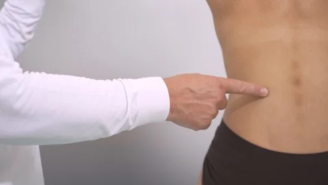 Medical doctor explaining back muscles and arm rotation at the hospital Stock Footage