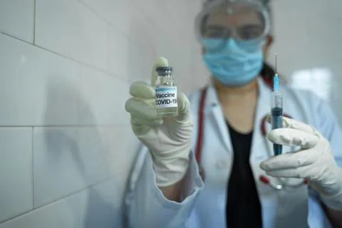 A medical doctor looking at corona virus vaccine Stock Photos