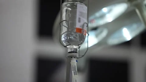 Medical dropper with saline solution in the foreground Stock Footage 252041358
