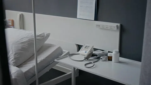 Medical Equipment Resting Beside Empty Bed in Hospital Room Stock Footage 345804884