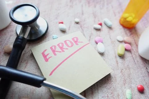 Medical error text on a paper with pills and stethoscope on table . 写真素材