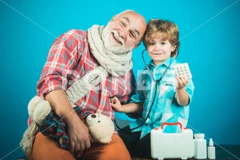 Medical examination boy cute child and his father doctor. Happy child and Stock Photos