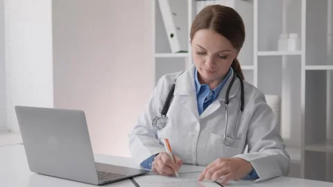 A medical expert, while serving patients, provides effective medical care and Stock Footage 260404422
