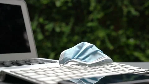 Medical face mask on computer keyboard on table. 動画素材 133160939