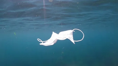 Medical face mask floating underwater. Used surgical mask on ocean water-Dan Stock Footage 134281180