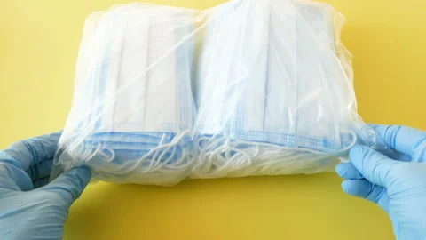 Medical face masks and respirators for donation on blue background Stock Footage 153405015