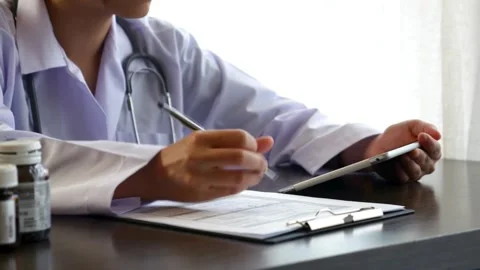 Medical form doctor is making notes in the patient's medical record. and asthma Stock-Footage 336587573