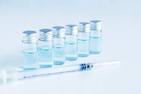 Medical glass vials and syringe for vaccination. Stock Photos