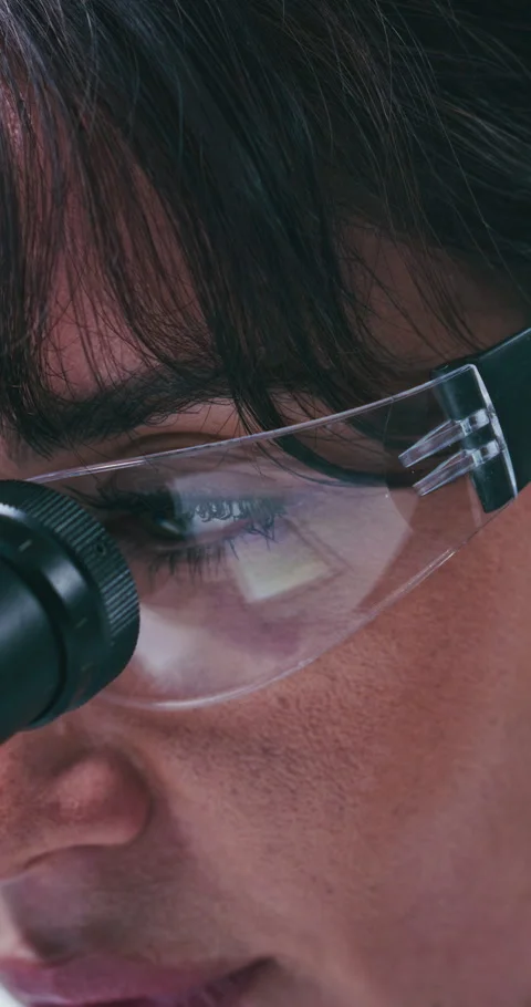 Medical, goggles or scientist in clinic with microscope, closeup or examination Stock Footage 331591453