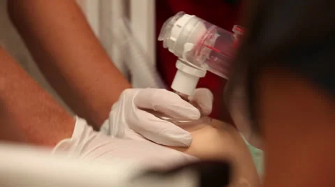 Medical hands performing CPR on a dummy Video stock 56567043