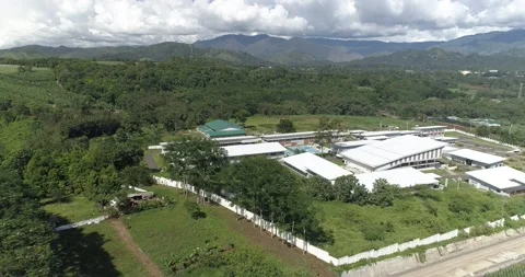 A medical health facility compound surrounded by green mountains Stock Footage 230049341