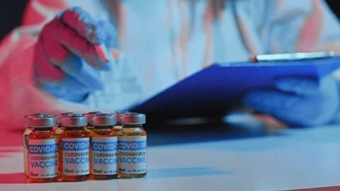 Medical immunization. Doctor hand in blue protective glove ppe counting vial Stock Footage 165335853