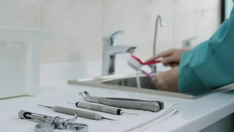 Medical instruments on the background of doctor's hands washing dental tools 動画素材 131532495