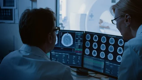 In Medical Laboratory Patient Undergoes MRI or CT Scan Procedure in Control Room Stock Footage