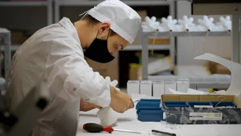 Medical Lamp Assembly. Operator Attaching a Tag on a Component. Lamps Housings Stock Footage 169984661