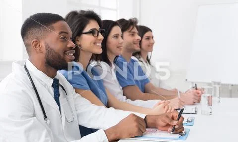 Medical lecture. Doctors and interns listening to professor Stock Photos