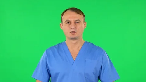 Medical man talking and pointing side hand for something, copy space. Green Stock Footage 123257341