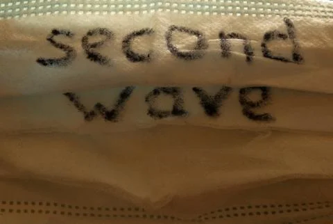 Medical mask with the inscription "second wave", covid-19. Stock Photos