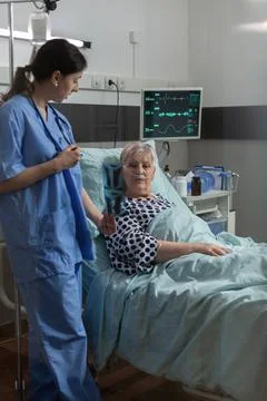 Medical nurse explaining chest x-ray radiography to elderly patient Stock Photos