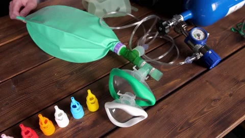 Medical oxygen cylinder connected to an inhaler mask with a breathing bag Stock Footage
