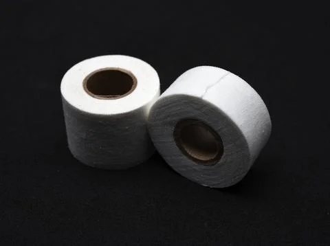 A medical patch on a black background. Two rolls of Band-Aid. Fotos de archivo