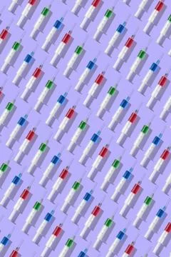 Medical pattern from plastic multicolored disposable syrenges. Stock Photos