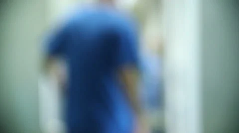 Medical personal walking in the hall of hospital, unfocused background Stock Footage