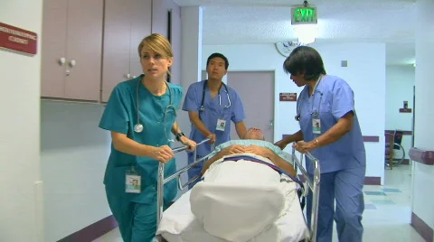 Medical personnel in hospital with patient Stock Footage