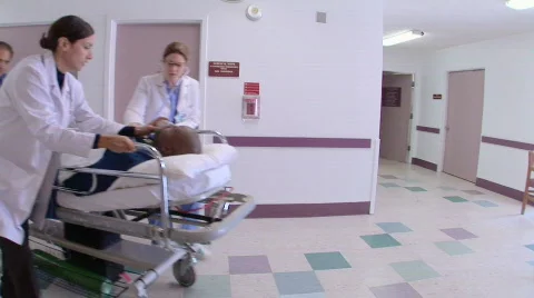 Medical personnel in hospital with patient Stock Footage