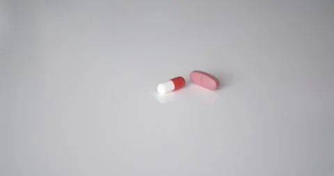 Medical pills fall on the table Видео 133490720