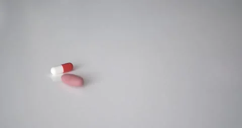 Medical pills fall on the table Видео 133490984