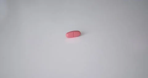 Medical pills fall on the table Видео 133491451