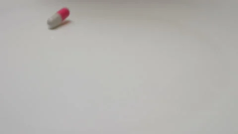 Medical pills falling down. Many coloured capsules, pills fall and run around Stock Footage 86172645