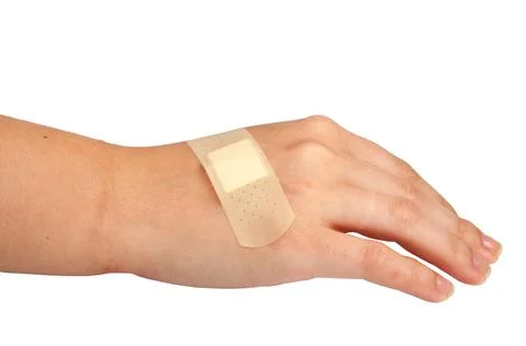 Medical plaster or patch on hand isolated on the white Stock Photos