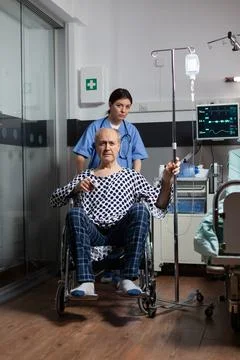 Medical practitioner preparing senior sick hospitalized man Stock Photos