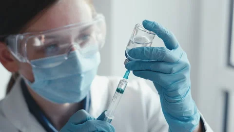 A medical professional is getting ready to administer a vaccine injection Stock Footage 277932748