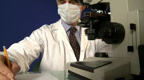 Medical professional looking through a microscope  動画素材 641475